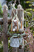 Christmas decoration with candles and cinnamon stars on the garden fence