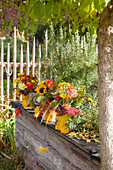 Autumn bouquets in vases wrapped in leaves