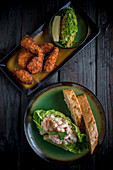 Fried Chicken with Avocado Salas and Prawn Cocktail on Black Background
