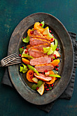 Asian duck breast with pomegranate on a tangerine and celery salad