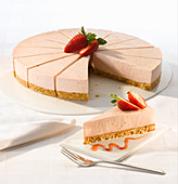 Strawberry cheesecake with a biscuit base serves fourteen