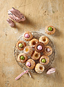 Mini Bundt cakes on a wire rack with dyed quail's eggs and Easter decorations