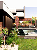 Garden with pool at the modern house with nested facade