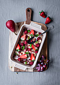 Fruit salad with berries, pears, pomegranate seeds and mint for Easter
