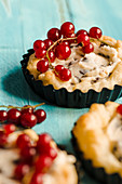 Puff pastry tartlets with chocolate and mascarpone cream and redcurrants