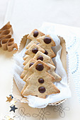 Gluten-free shortbread biscuits shaped like Christmas trees with chocolate drops