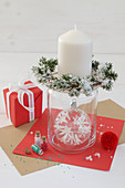 Candlestick made from glass jar with wreath of fir and Christmas-tree bauble