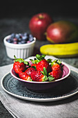 Fresh strawberries in a small dish