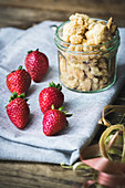 Strawberries and a jar of crumbles as ingredients for cake or dessert
