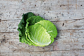 Savoy cabbage leaves on a wooden surface