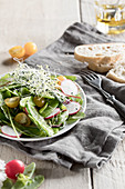 Mange tout salad with beansprouts, radishes and yellow tomatoes
