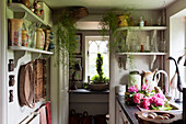 Collection of vases on shelves in small country-house kitchen