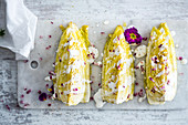 Oven-roasted Chinese cabbage wedges garnished with edible flowers