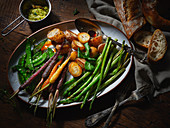 A vegetable platter with potatoes, asparagus, carrots and mange tout