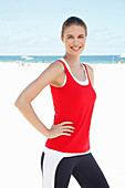 A young woman on the beach wearing sports clothing