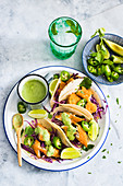 Baja fish tacos with red cabbage, jalapenos and avocado dressing