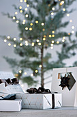 Elegantly wrapped presents in front of the Christmas tree