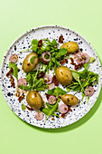 New potato salad with dried tomatoes and rocket