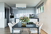 Modern dining table in minimalist kitchen-dining room in grey and beige