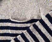 A hand-knitted striped jumper with a breast pocket