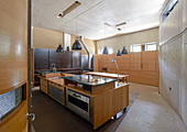Wood and concrete kitchen in experimental architect-designed house