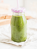 Green vegan smoothie in a bottle