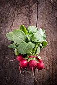 A bunch of radishes on a wooden background