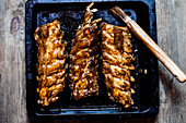 Sticky spareribs with homemade BBQ glaze on a oven tray
