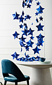 Blue DIY paper stars over dining table