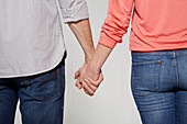 A man and a woman walking hand in hand (body language: 'setting the tone')