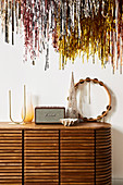 Sideboard with decorative objects, tinsel above
