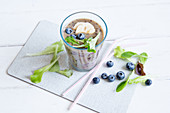 A blueberry smoothie with mixed leaves