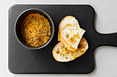 Homemade curry powder served with bread on a chopping board