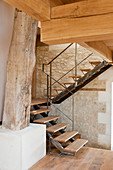 Staircase leading to gallery in converted, renovated barn