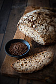 Linseed bread and flax seed on a wooden cutting board