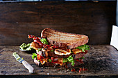 Brown bread sandwich with bacon and chicken