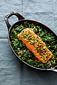 Salmon with a nut crust on a bed of spinach