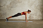 A young woman performing a push-up