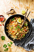 Dark Bowl of Thai street food, tofu, noodles and vegetable