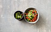 Bean chilli with an avocado and coriander topping