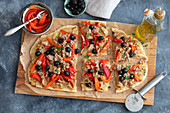 Flammenkuchen with braised onion, tuna and olives