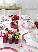 Festively set table with handmade flower arrangements