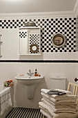 Black-and-white bathroom with chequered wall tiles