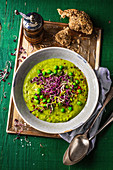 Pureed pea soup with sprouts