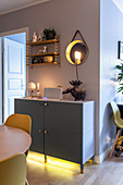 Sideboard with under-cabinet lighting in dining room