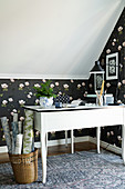 Black rose-patterned wallpaper in study