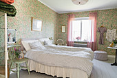Granny-chic bedroom with romantic floral wallpaper
