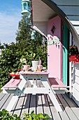 Table and benches on terrace of play house in American fifties style