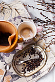 Filter coffee next to coffee beans and spoon on vintage metal plate
