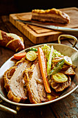 Beer-braised pork with a lye gravy and braised onions